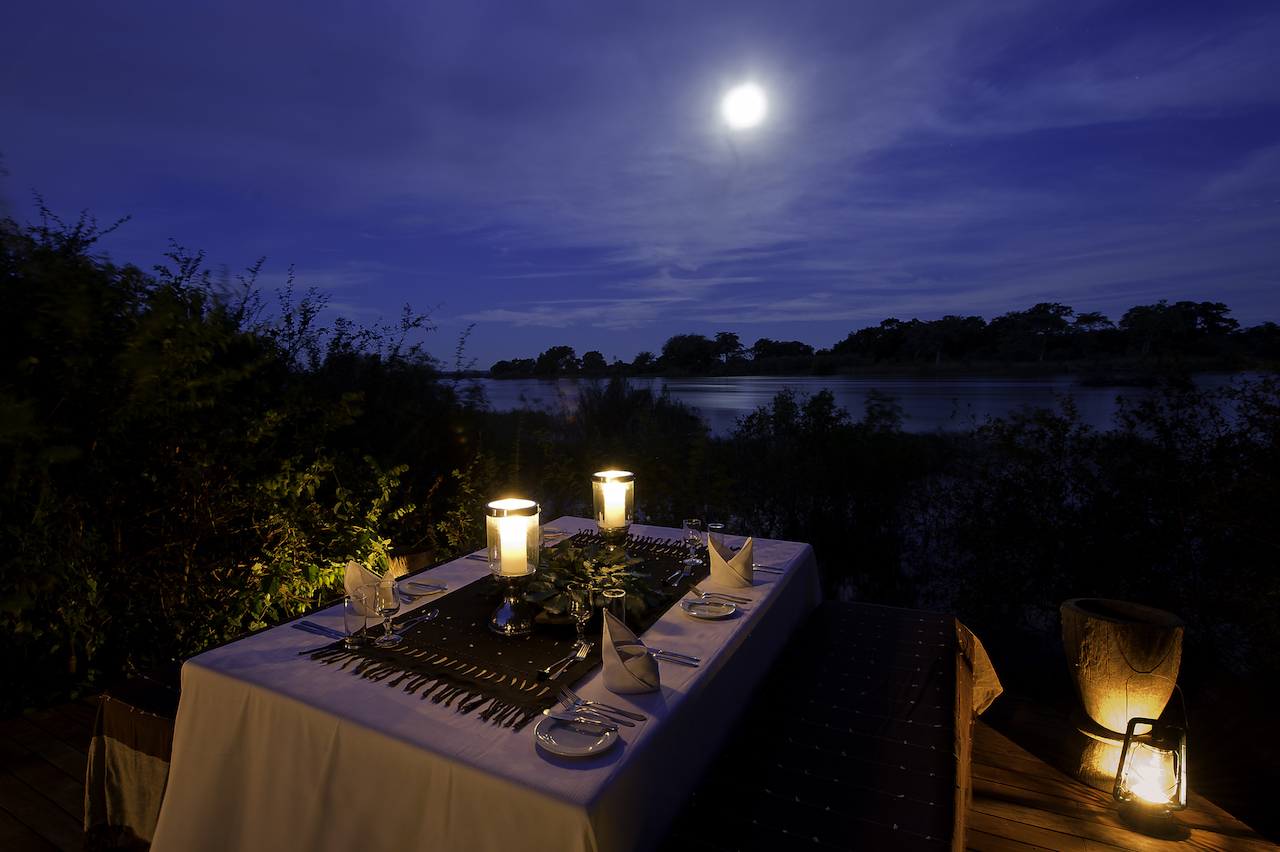 Dining under a full moon on Sindabezi Island, just above Victoria Falls. Photo credit: Tongabezi Lodge.