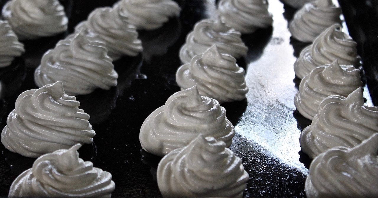 Meringues are piped and ready to be cooked in a low oven.